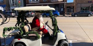 Santa driving a golf cart