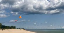 Kites flying over a beach at Lake Michigan