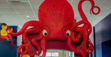 A large red 3D octopus over a doorway at Lester Public Library