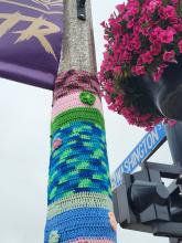 Yarn art on a lamp post.