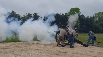 Civil War reenactors firing a canon.